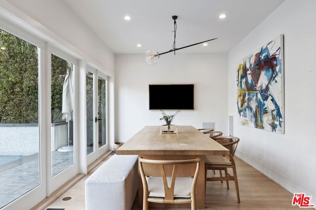 dining room with a chandelier and light hardwood / wood-style floors