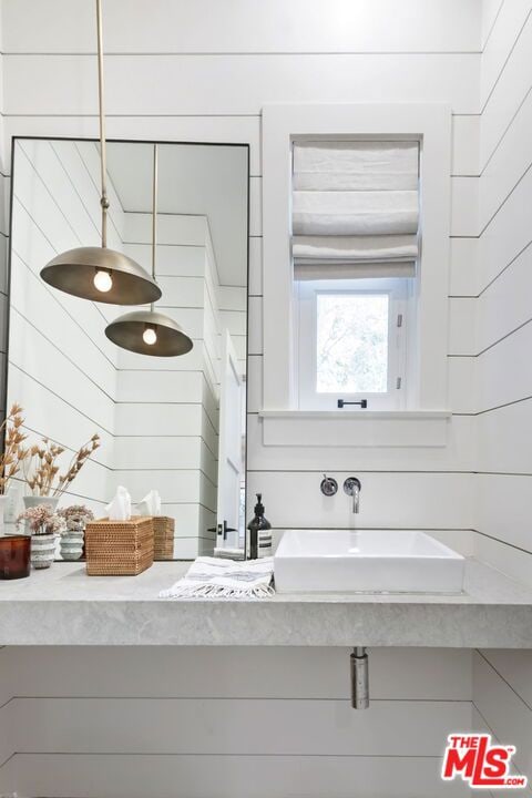 interior space with sink and wood walls