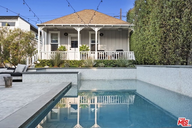 view of swimming pool featuring covered porch and a patio area