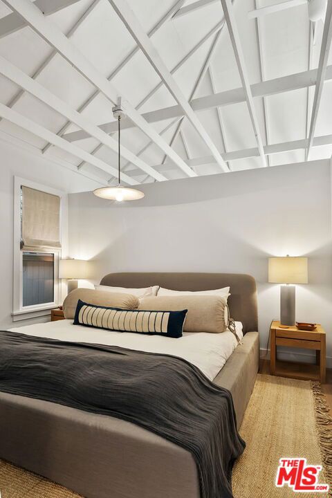 bedroom with lofted ceiling with beams