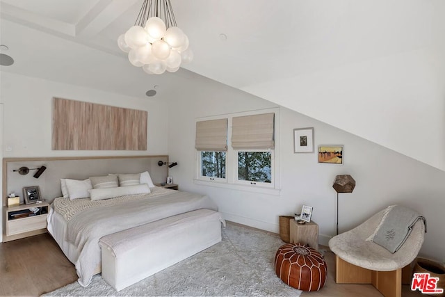 bedroom with lofted ceiling with beams, a notable chandelier, and light wood-type flooring