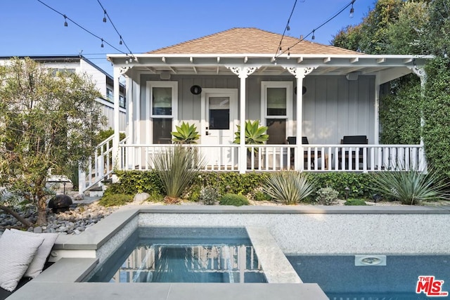 back of property featuring a porch