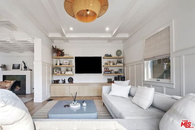 living room featuring beam ceiling and light hardwood / wood-style floors