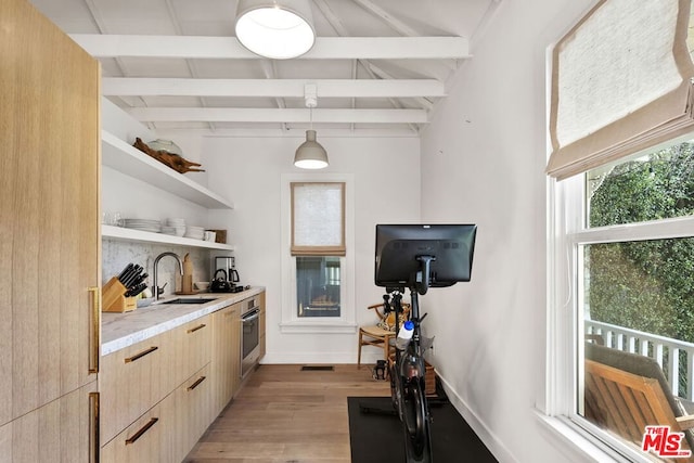 exercise room with lofted ceiling, sink, and light hardwood / wood-style floors