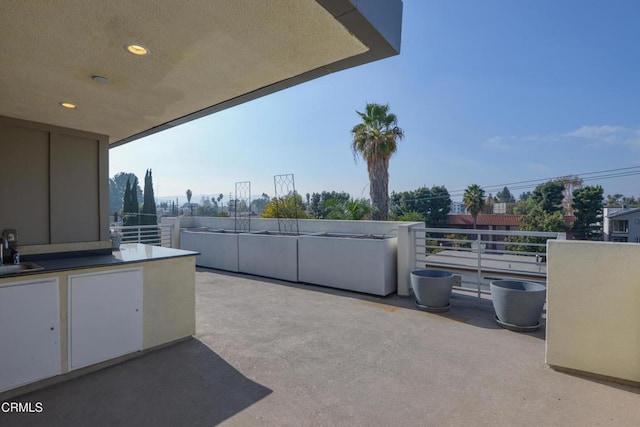 view of patio / terrace with a balcony and sink