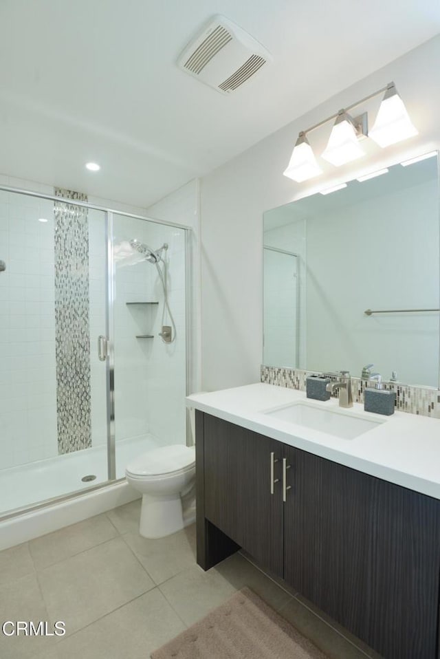 bathroom with vanity, an enclosed shower, decorative backsplash, tile patterned floors, and toilet