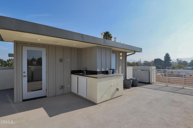 view of patio with area for grilling and sink