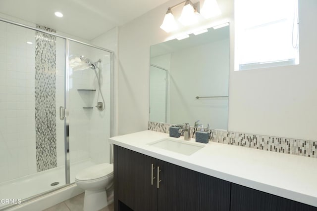 bathroom with vanity, an enclosed shower, tile patterned floors, and toilet