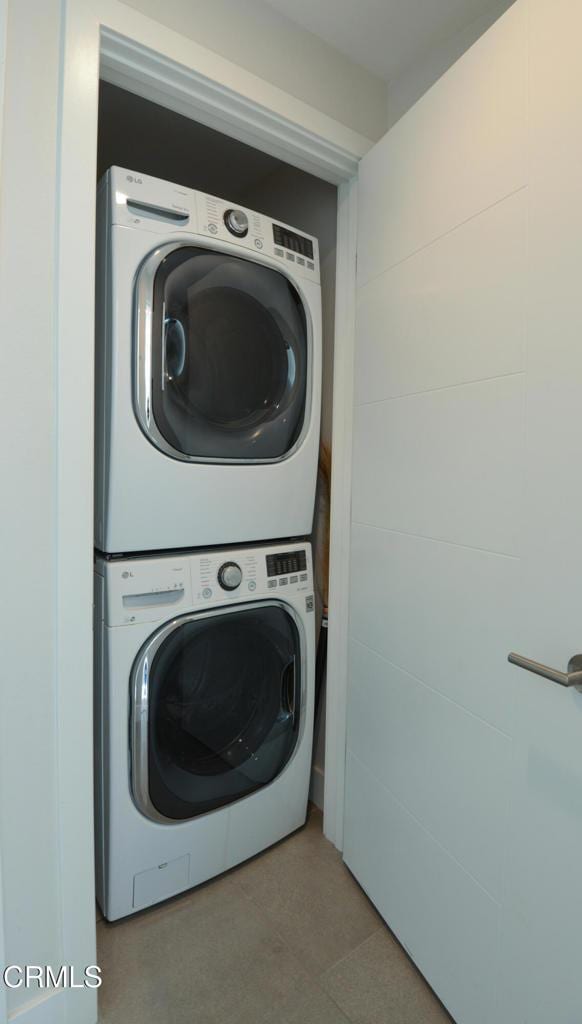 washroom featuring stacked washer / dryer