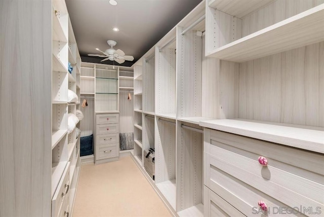 walk in closet featuring ceiling fan