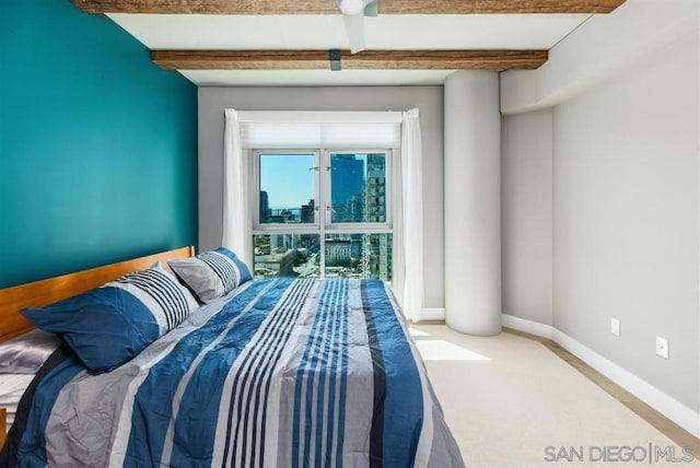 bedroom with beamed ceiling and carpet