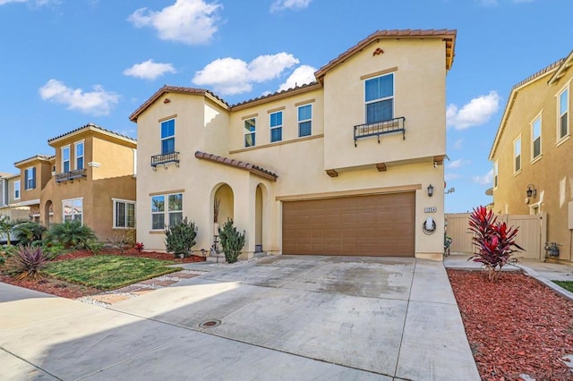 mediterranean / spanish-style home with a garage