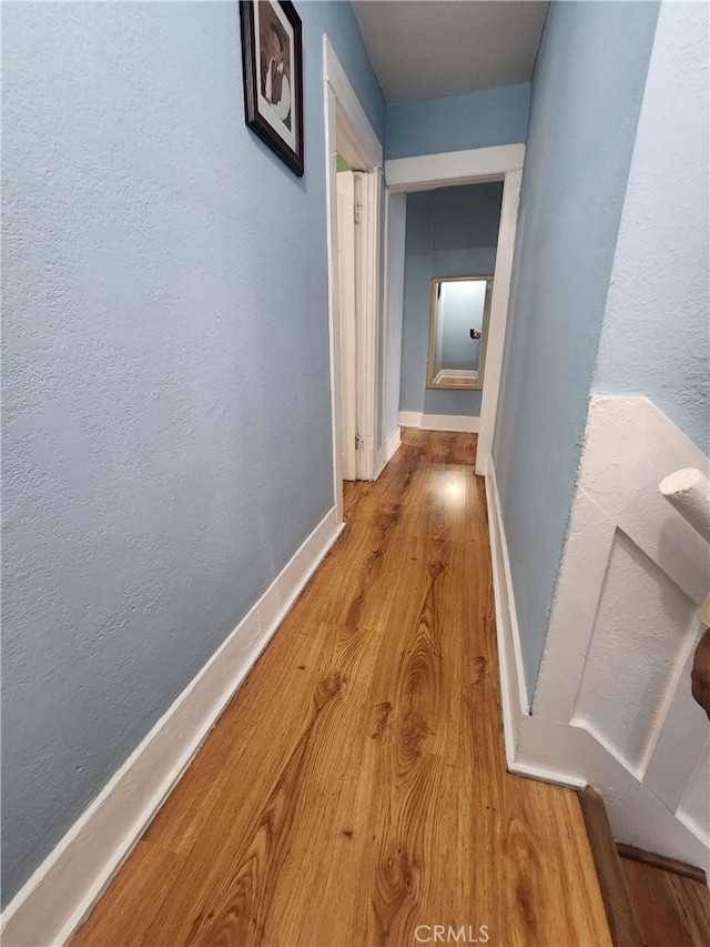 hall with hardwood / wood-style flooring