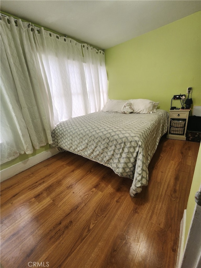 bedroom with hardwood / wood-style flooring