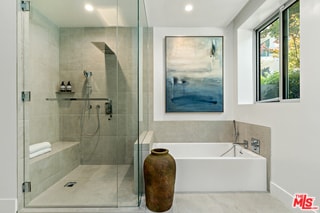 bathroom featuring separate shower and tub