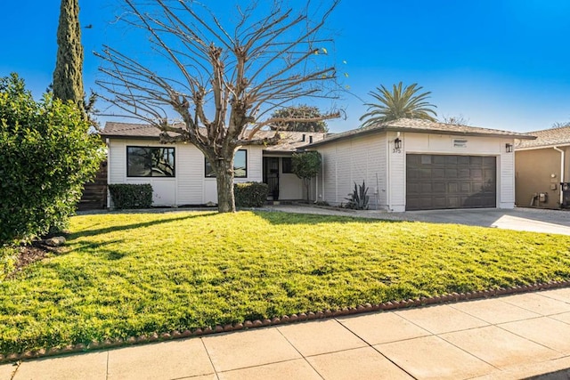 ranch-style home with a garage and a front yard