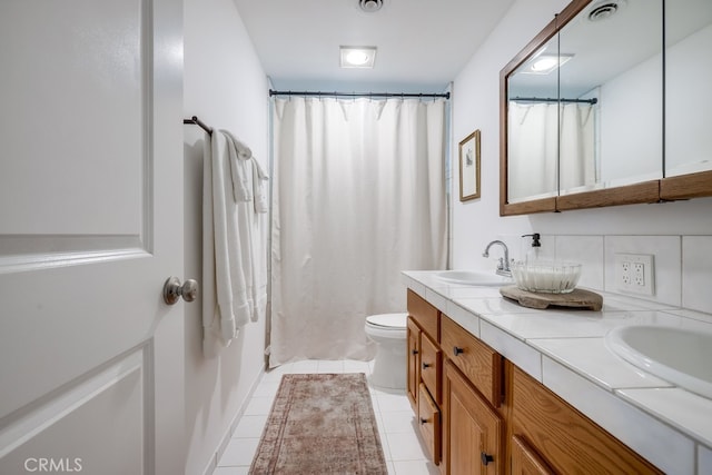 bathroom with vanity, tile patterned floors, and toilet