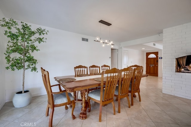 tiled dining area featuring an inviting chandelier