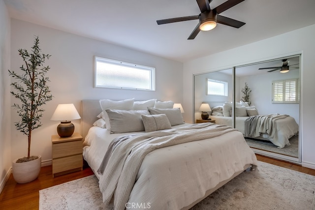 bedroom featuring hardwood / wood-style floors, a closet, and ceiling fan