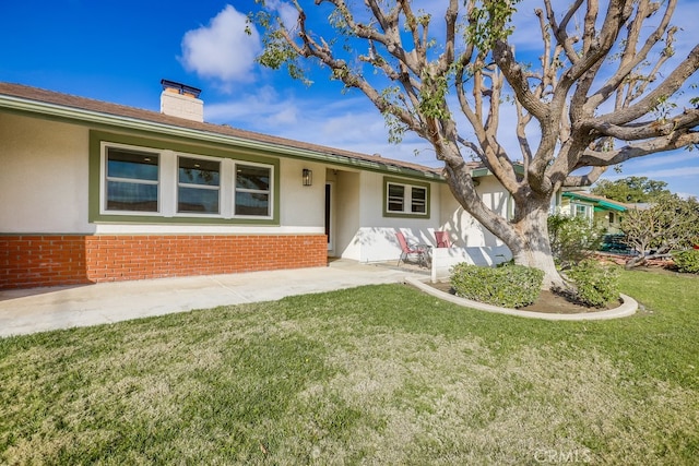 ranch-style home with a patio and a front yard