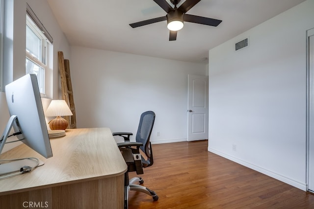 office space featuring dark hardwood / wood-style flooring and ceiling fan