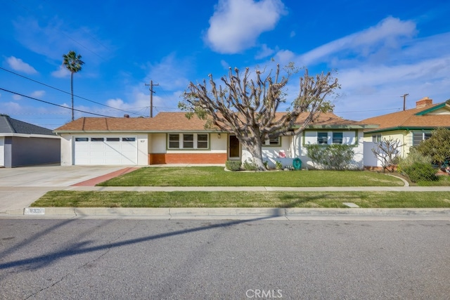 ranch-style home with a garage and a front lawn