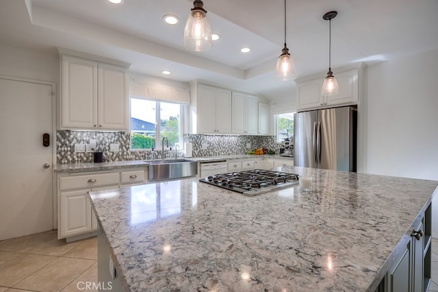 kitchen featuring white cabinetry, appliances with stainless steel finishes, and a center island