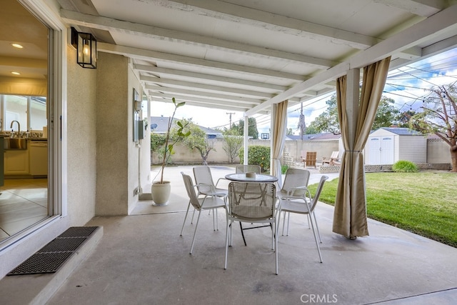 view of patio featuring a storage unit