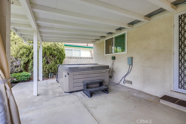 view of patio / terrace with a hot tub