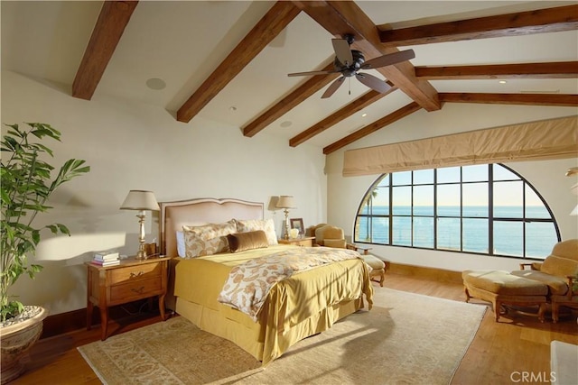 bedroom featuring hardwood / wood-style flooring, a water view, vaulted ceiling with beams, and ceiling fan