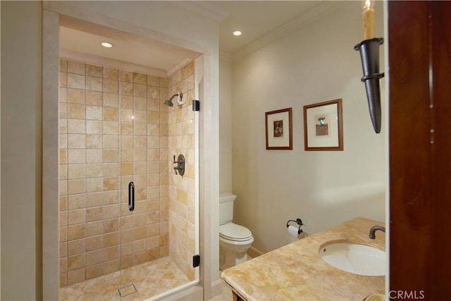 bathroom with vanity, crown molding, a shower with shower door, and toilet