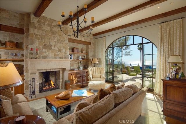 living room featuring a large fireplace, a notable chandelier, and beam ceiling