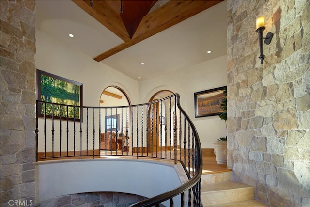 staircase featuring vaulted ceiling with beams