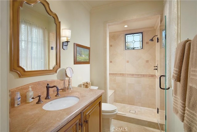 bathroom featuring ornamental molding, toilet, a shower with door, and vanity