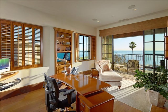 office area with plenty of natural light and light hardwood / wood-style floors