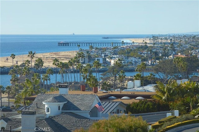 birds eye view of property featuring a water view and a beach view