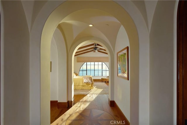 corridor featuring lofted ceiling with beams