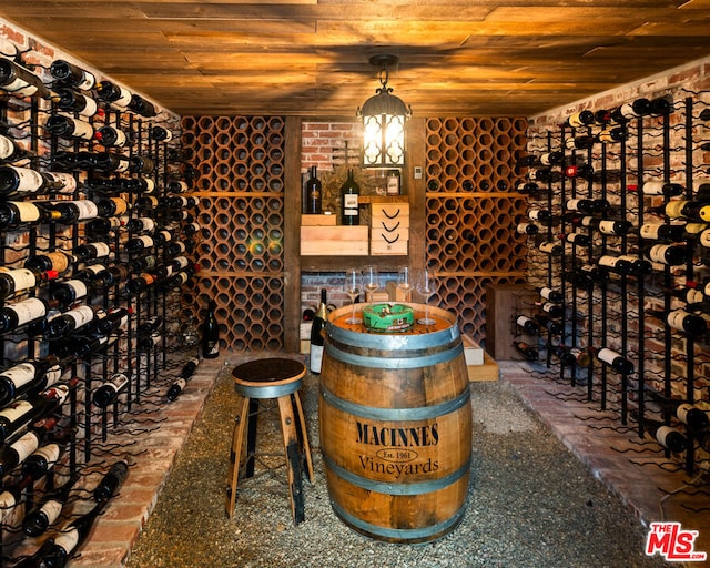 wine cellar featuring wooden ceiling and brick wall