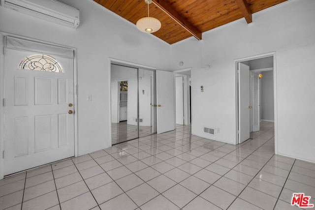 foyer entrance with an AC wall unit, high vaulted ceiling, light tile patterned floors, wooden ceiling, and beam ceiling