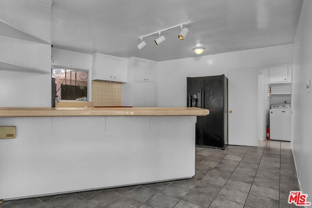 kitchen featuring white cabinetry, washer / dryer, tile counters, and black fridge with ice dispenser