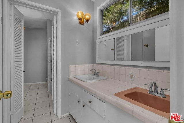 bathroom featuring tasteful backsplash, vanity, and tile patterned floors