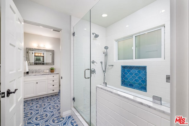 bathroom with walk in shower and vanity