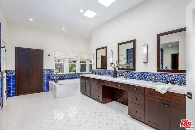 bathroom featuring vanity and a tub to relax in