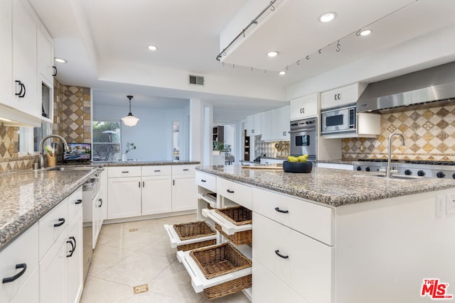 kitchen with backsplash, appliances with stainless steel finishes, light stone counters, and white cabinets