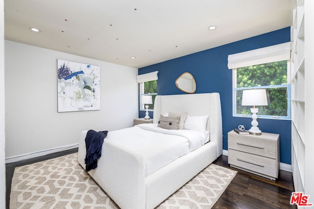 bedroom with dark hardwood / wood-style flooring