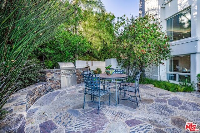 view of patio / terrace featuring area for grilling and a grill