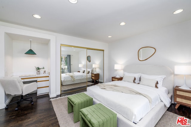 bedroom featuring dark hardwood / wood-style flooring and a closet