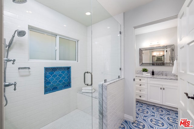 bathroom featuring vanity and a shower with shower door