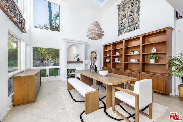 tiled dining area featuring a high ceiling