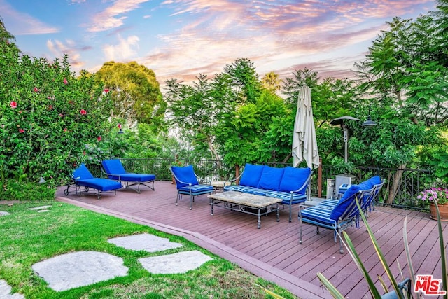 deck at dusk with outdoor lounge area